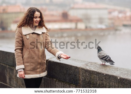 the girl feeds a dove