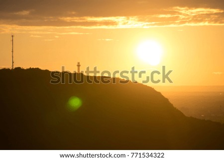 Cross on a mountain at sunset