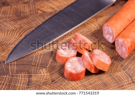 Sliced sausage on an oak board sharp. Kitchen knife