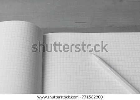 A large blank notebook and pen. 