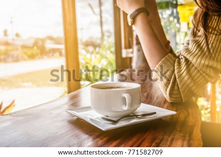 Woman and a cup of coffee in his cafe. Royalty-Free Stock Photo #771582709