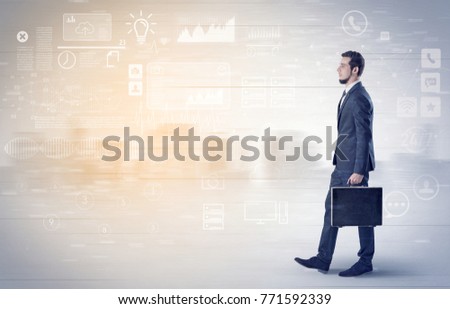 Handsome businessman walking in suit with briefcase on his hand and database concept around
