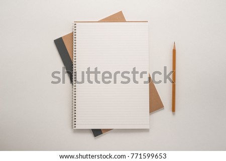 Notepad with a pencil on the table