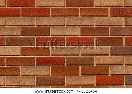 Modern multicolored brown brick wall background in traditional running bond pattern