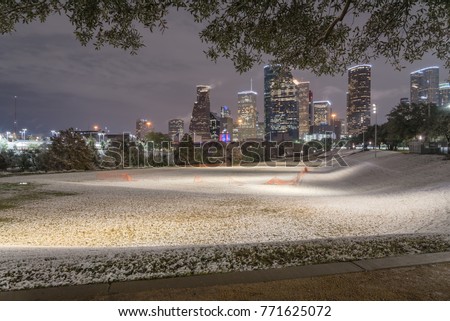 Unusual snow in Downtown Houston with big and fluffy snowflakes fell on meadow grass at Eleanor Park. Snow is extremely rarely happen and it has only fallen in Houston 35 times since February 1895.