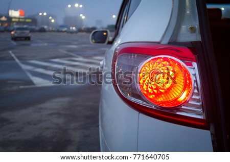 White Hyundai Santa FE on the parking. Red stoplights looks great on that SUV at night Royalty-Free Stock Photo #771640705