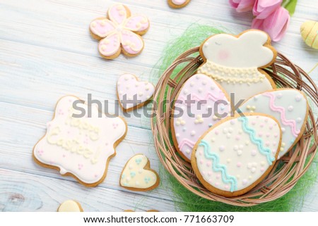 Easter cookies in basket on wooden table