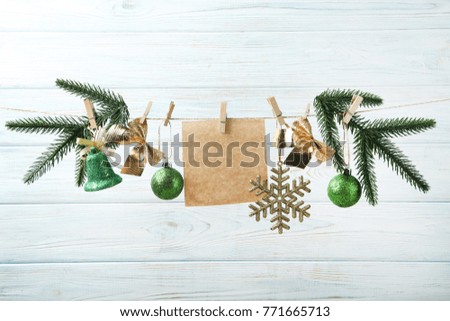 Christmas decorations with blank sheet of paper hanging on rope