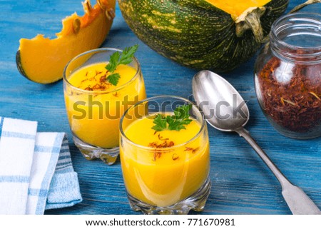 Cold pumpkin cream soup in glasses. Studio Photo
