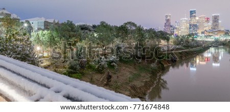Panorama view unusual snowfall along Bayou River bank with downtown Houston, Texas, USA skylines city lights reflection at sunrise/twilight. Snow is extremely rarely and happen only 35 time since 1895