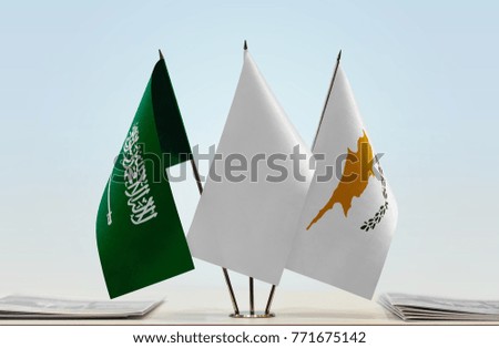 Flags of Saudi Arabia and Cyprus with a white flag in the middle