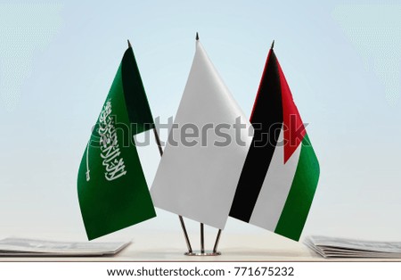 Flags of Saudi Arabia and Jordan with a white flag in the middle