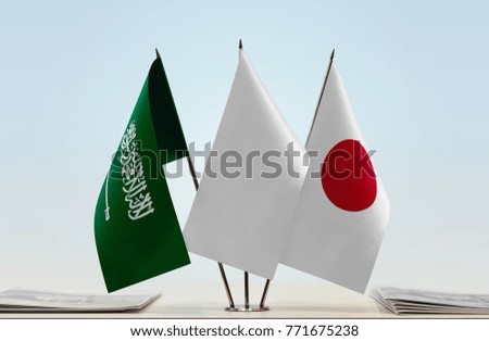 Flags of Saudi Arabia and Japan with a white flag in the middle