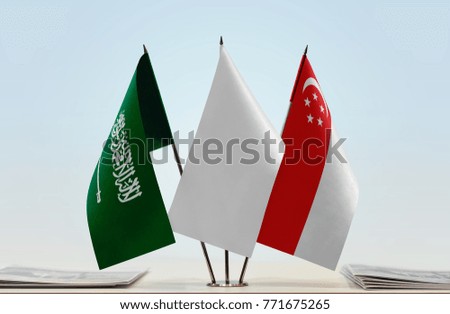 Flags of Saudi Arabia and Singapore with a white flag in the middle