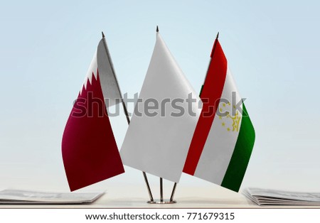 Flags of Qatar and Tajikistan with a white flag in the middle