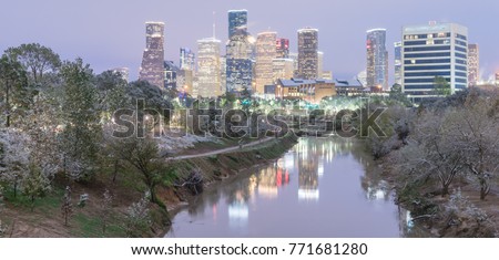Panorama view unusual snowfall along Bayou River bank with downtown Houston, Texas, USA skylines city lights reflection at sunrise/twilight. Snow is extremely rarely and happen only 35 time since 1895