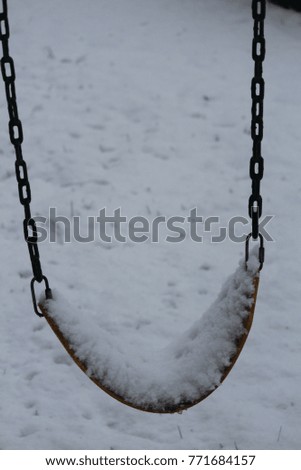 snow on swings in winter