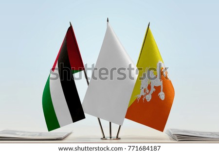 Flags of Palestine and Bhutan with a white flag in the middle