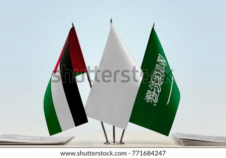 Flags of Palestine and Saudi Arabia with a white flag in the middle