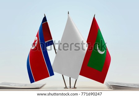 Flags of North Korea and Maldives with a white flag in the middle