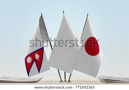 Flags of Nepal and Japan with a white flag in the middle