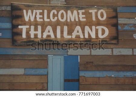 Welcome to thailand word on vintage wooden background