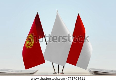 Flags of Kyrgyzstan and Indonesia with a white flag in the middle