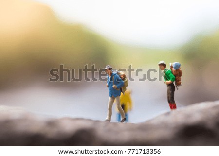 Miniature people, travelers with backpack walking to destination using as travel business concept