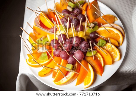 Assorted fresh sliced fruit on a plate. Close up photo