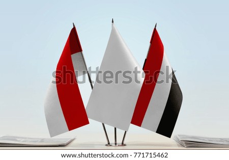 Flags of Indonesia and Yemen with a white flag in the middle