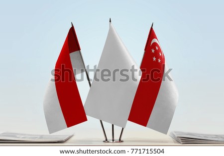Flags of Indonesia and Singapore with a white flag in the middle