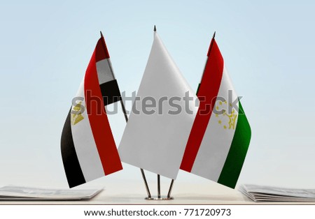 Flags of Egypt and Tajikistan with a white flag in the middle