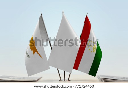 Flags of Cyprus and Tajikistan with a white flag in the middle