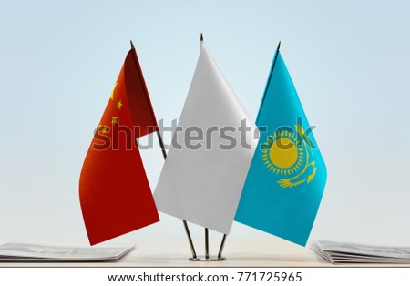 Flags of China and Kazakhstan with a white flag in the middle
