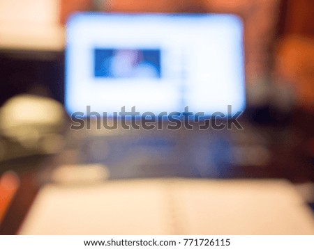 Blur picture of computer on table for working space