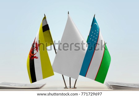 Flags of Brunei and Uzbekistan with a white flag in the middle