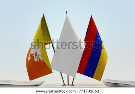 Flags of Bhutan and Armenia with a white flag in the middle
