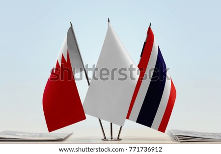 Flags of Bahrain and Thailand with a white flag in the middle