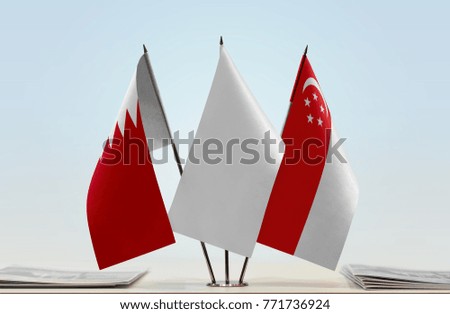 Flags of Bahrain and Singapore with a white flag in the middle