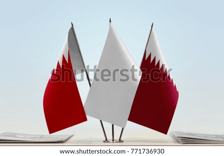 Flags of Bahrain and Qatar with a white flag in the middle