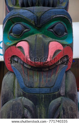View of ancient colorful Totem Pole with blue sky behind it in Duncan, British Columbia, Canada.