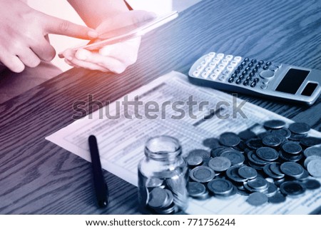 Business technology people are calculating costs online payment.cellphone, calculator
,mobile banking.calculate money and Payment Documents concept Planned spending Revenue To invest effectively.