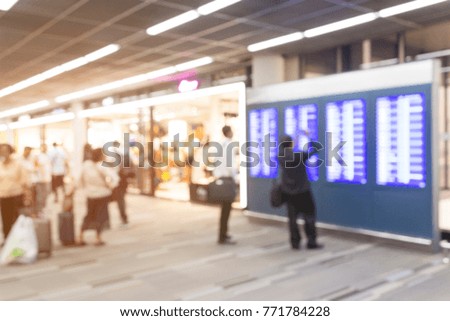 Blurred picture of people are checking the plane schedule