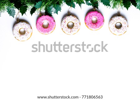 Patterns and mockups of white and pink donuts with mistletoe and Christmas toys on the white background flat lay