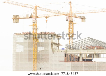 Crane,Construction cranes equipment over building construction site on white background,technology transportation material to high. 