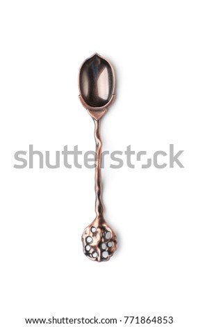An old tea spoon in the form of an acorn. Isolated on white background.
