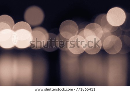 Abstract Blur Bokeh Gold Lights Defocused Background Sepia Vintage Tone. Circular Bokeh Magic Holy Christmas Party Night on Out of Focus Dark Background or Backdrop or Wallpaper or Pattern or Texture