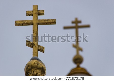 Picture of the christian church with golden dome and Cross on the top close up. Golden dome and Cross on the top against background of gray sky.