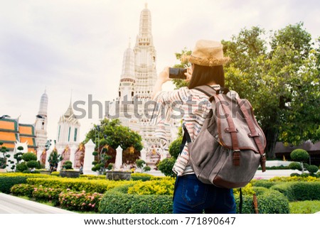 Asian woman tourist using smartphone shooting Wat Arun temple, Relax time on vacation hipster lifestyle