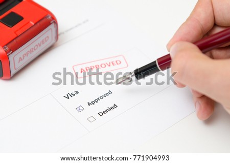 Visa and approved stamp on a document form. Immigration and travel concept Royalty-Free Stock Photo #771904993